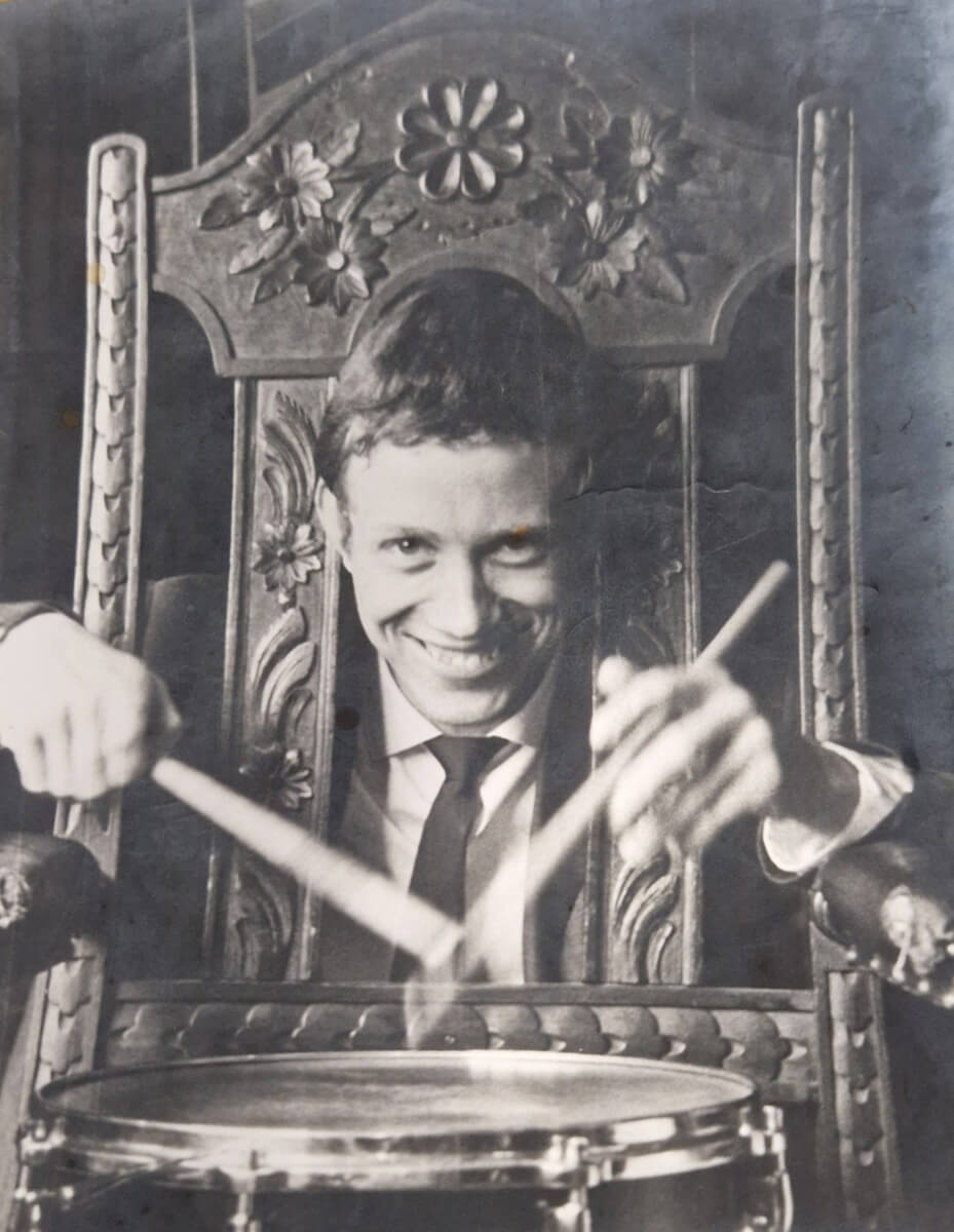 Young Tony Scriven drumming through a chair
