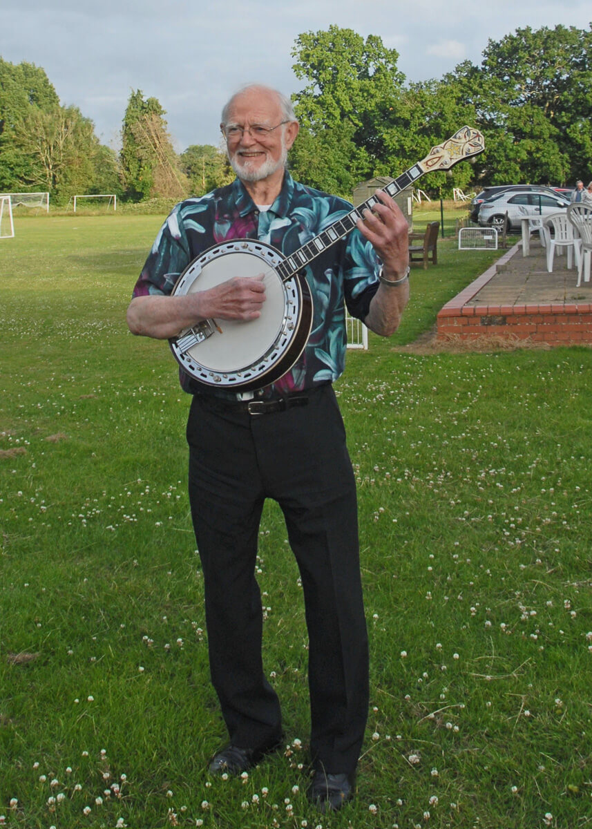 Bill Stagg standing with banjo