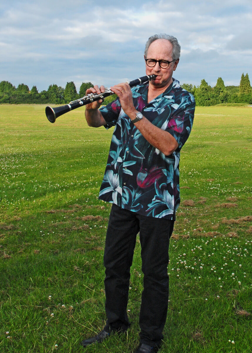 Tim Asson standing with clarinet